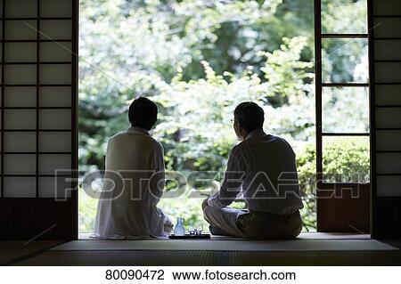 Stock Image - Japanese senior couple having fun at traditional inn. Fotosearch