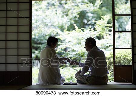 Stock Image - Japanese senior couple having fun at traditional inn. Fotosearch