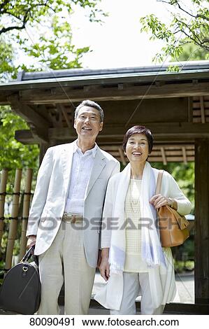 Stock Image - Japanese senior couple having fun at traditional inn. Fotosearch