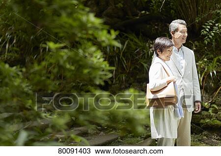 Stock Image - Japanese senior couple having fun at traditional inn. Fotosearch