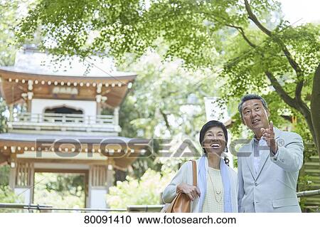 Stock Image - Japanese senior couple having fun at traditional inn. Fotosearch