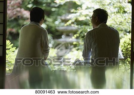 Stock Image - Japanese senior couple having fun at traditional inn. Fotosearch
