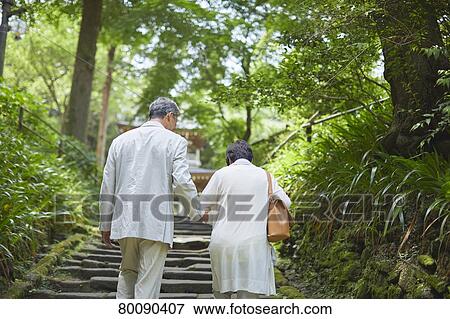 Stock Photo - Japanese senior couple having fun at traditional inn. Fotosearch