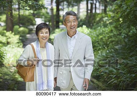 Stock Photo - Japanese senior couple having fun at traditional inn. Fotosearch
