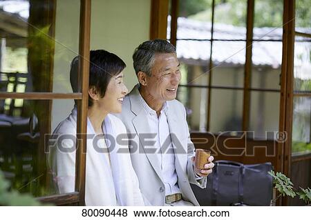 Stock Photo - Japanese senior couple having fun at traditional inn. Fotosearch