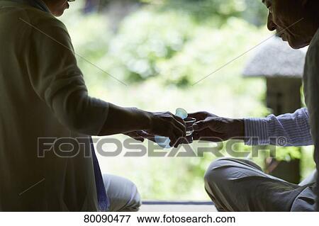 Stock Photo - Japanese senior couple having fun at traditional inn. Fotosearch