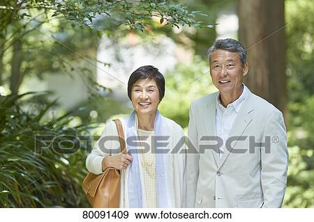 Stock Photo - Japanese senior couple having fun at traditional inn. Fotosearch