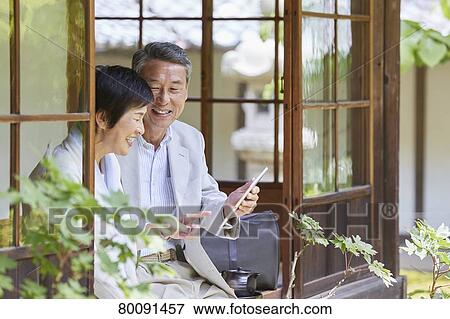Japanese senior couple having fun at traditional inn View Large Photo Image Stock Photo - Japanese senior couple having fun at traditional inn. Fotosearch