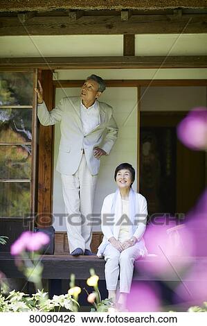 Stock Photograph - Japanese senior couple having fun at traditional inn. Fotosearch