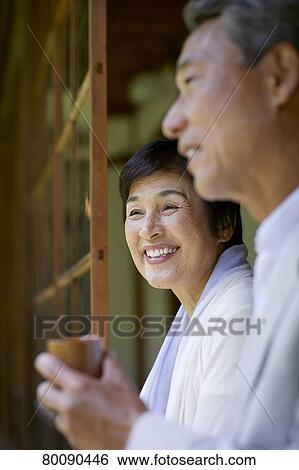 Stock Photograph - Japanese senior couple having fun at traditional inn. Fotosearch
