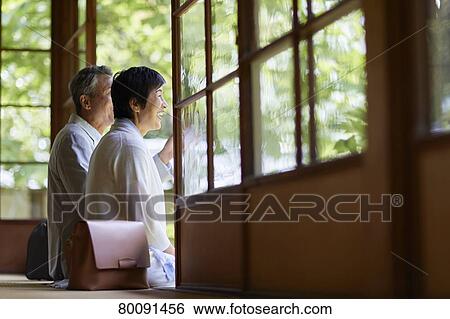 Stock Photograph - Japanese senior couple having fun at traditional inn. Fotosearch