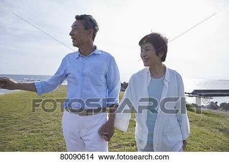 Japanese senior couple having fun by the sea View Large Photo Image Picture - Japanese senior couple having fun by the sea. Fotosearch