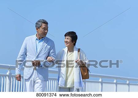 Japanese senior couple having fun by the sea View Large Photo Image Picture - Japanese senior couple having fun by the sea. Fotosearch