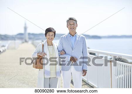 Japanese senior couple having fun by the sea View Large Photo Image Stock Image - Japanese senior couple having fun by the sea. Fotosearch