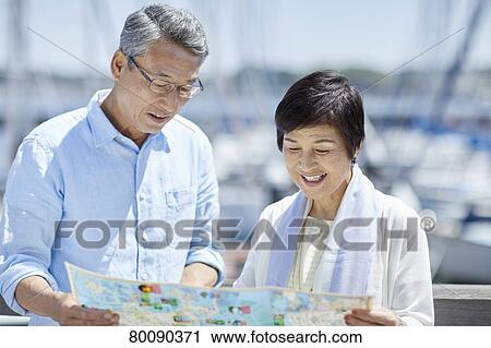 Japanese senior couple having fun by the sea View Large Photo Image Stock Image - Japanese senior couple having fun by the sea. Fotosearch