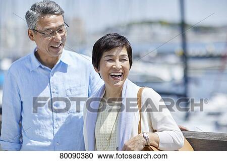 Japanese senior couple having fun by the sea View Large Photo Image Stock Image - Japanese senior couple having fun by the sea. Fotosearch