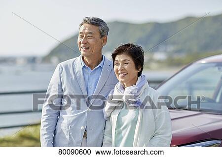 Japanese senior couple having fun by the sea View Large Photo Image Stock Image - Japanese senior couple having fun by the sea. Fotosearch