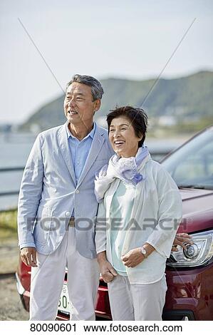 Japanese senior couple having fun by the sea View Large Photo Image Stock Image - Japanese senior couple having fun by the sea. Fotosearch
