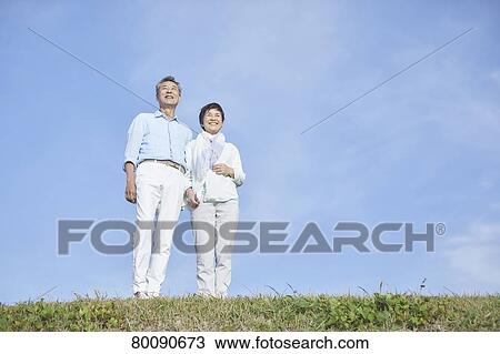 Japanese senior couple having fun by the sea View Large Photo Image Stock Image - Japanese senior couple having fun by the sea. Fotosearch