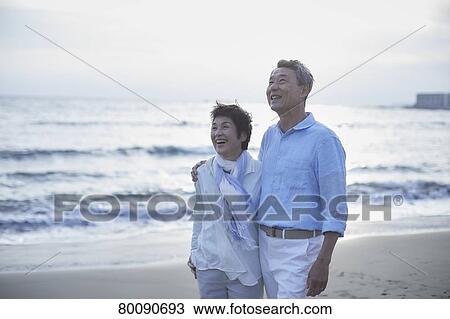 Japanese senior couple having fun by the sea View Large Photo Image Stock Image - Japanese senior couple having fun by the sea. Fotosearch