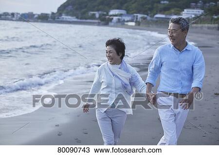 Japanese senior couple having fun by the sea View Large Photo Image Stock Image - Japanese senior couple having fun by the sea. Fotosearch