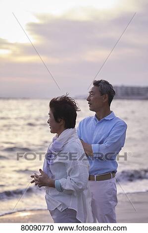 Japanese senior couple having fun by the sea View Large Photo Image Stock Image - Japanese senior couple having fun by the sea. Fotosearch