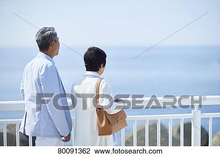 Japanese senior couple having fun by the sea View Large Photo Image Stock Image - Japanese senior couple having fun by the sea. Fotosearch