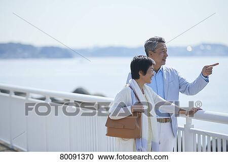 Japanese senior couple having fun by the sea View Large Photo Image Stock Image - Japanese senior couple having fun by the sea. Fotosearch
