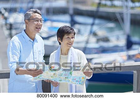 Japanese senior couple having fun by the sea View Large Photo Image Stock Image - Japanese senior couple having fun by the sea. Fotosearch
