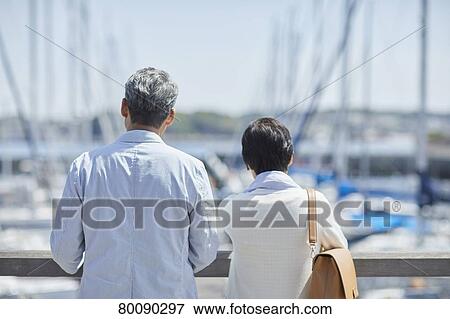 Japanese senior couple having fun by the sea View Large Photo Image Stock Photo - Japanese senior couple having fun by the sea. Fotosearch