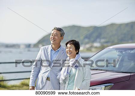 Japanese senior couple having fun by the sea View Large Photo Image Stock Photo - Japanese senior couple having fun by the sea. Fotosearch