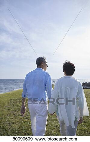 Japanese senior couple having fun by the sea View Large Photo Image Stock Photo - Japanese senior couple having fun by the sea. Fotosearch