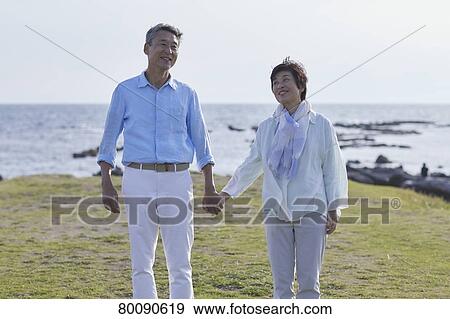 Japanese senior couple having fun by the sea View Large Photo Image Stock Photo - Japanese senior couple having fun by the sea. Fotosearch