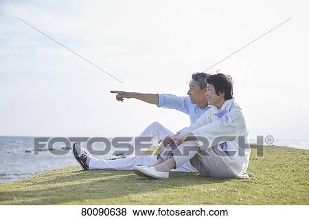 Japanese senior couple having fun by the sea View Large Photo Image Stock Photo - Japanese senior couple having fun by the sea. Fotosearch
