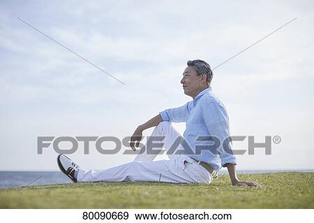 Japanese senior couple having fun by the sea View Large Photo Image Stock Photo - Japanese senior couple having fun by the sea. Fotosearch