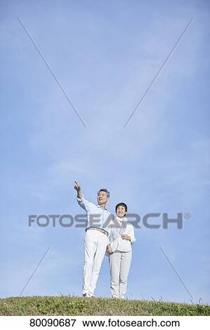 Japanese senior couple having fun by the sea View Large Photo Image Stock Photo - Japanese senior couple having fun by the sea. Fotosearch