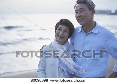 Japanese senior couple having fun by the sea View Large Photo Image Stock Photo - Japanese senior couple having fun by the sea. Fotosearch