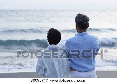 Japanese senior couple having fun by the sea View Large Photo Image Stock Photo - Japanese senior couple having fun by the sea. Fotosearch