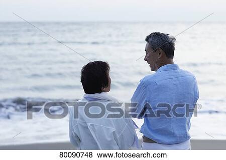 Japanese senior couple having fun by the sea View Large Photo Image Stock Photo - Japanese senior couple having fun by the sea. Fotosearch