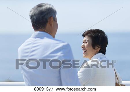 Japanese senior couple having fun by the sea View Large Photo Image Stock Photo - Japanese senior couple having fun by the sea. Fotosearch