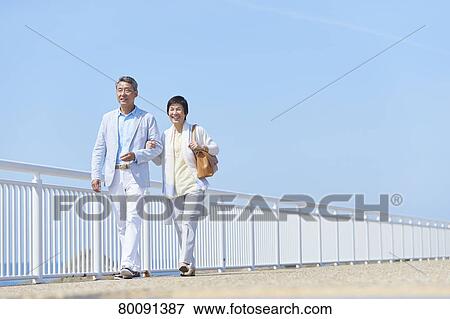 Japanese senior couple having fun by the sea View Large Photo Image Stock Photo - Japanese senior couple having fun by the sea. Fotosearch
