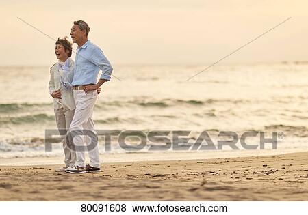 Japanese senior couple having fun by the sea View Large Photo Image Stock Photo - Japanese senior couple having fun by the sea. Fotosearch