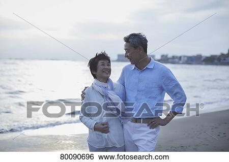 Japanese senior couple having fun by the sea View Large Photo Image Stock Photograph - Japanese senior couple having fun by the sea. Fotosearch