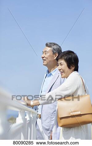 Japanese senior couple having fun by the sea View Large Photo Image Stock Photography - Japanese senior couple having fun by the sea. Fotosearch