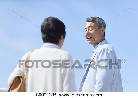 Japanese senior couple having fun by the sea View Large Photo Image Stock Photography - Japanese senior couple having fun by the sea. Fotosearch