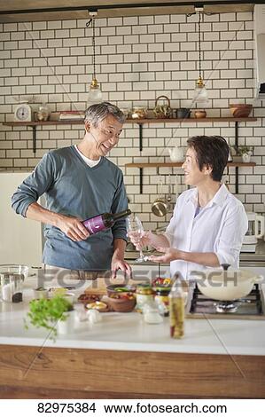 Picture - Japanese senior couple in the kitchen. Fotosearch