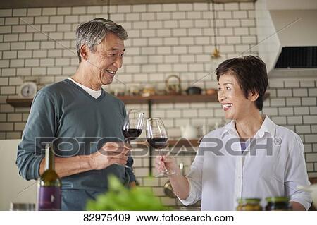 Stock Photo - Japanese senior couple in the kitchen. Fotosearch