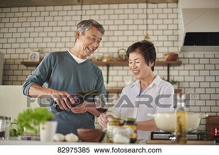 Stock Photography - Japanese senior couple in the kitchen. Fotosearch