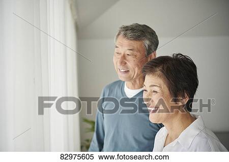 Stock Photography - Japanese senior couple in the living room. Fotosearch