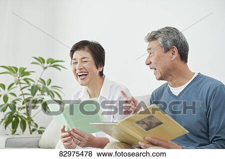 Stock Photo - Japanese senior couple on the sofa. Fotosearch